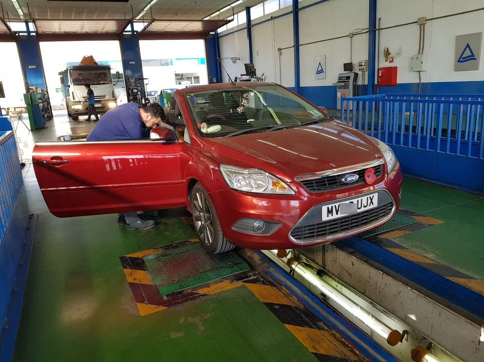 Ford Focus being inspected during ITV import test Ford Focus over pit at ITV